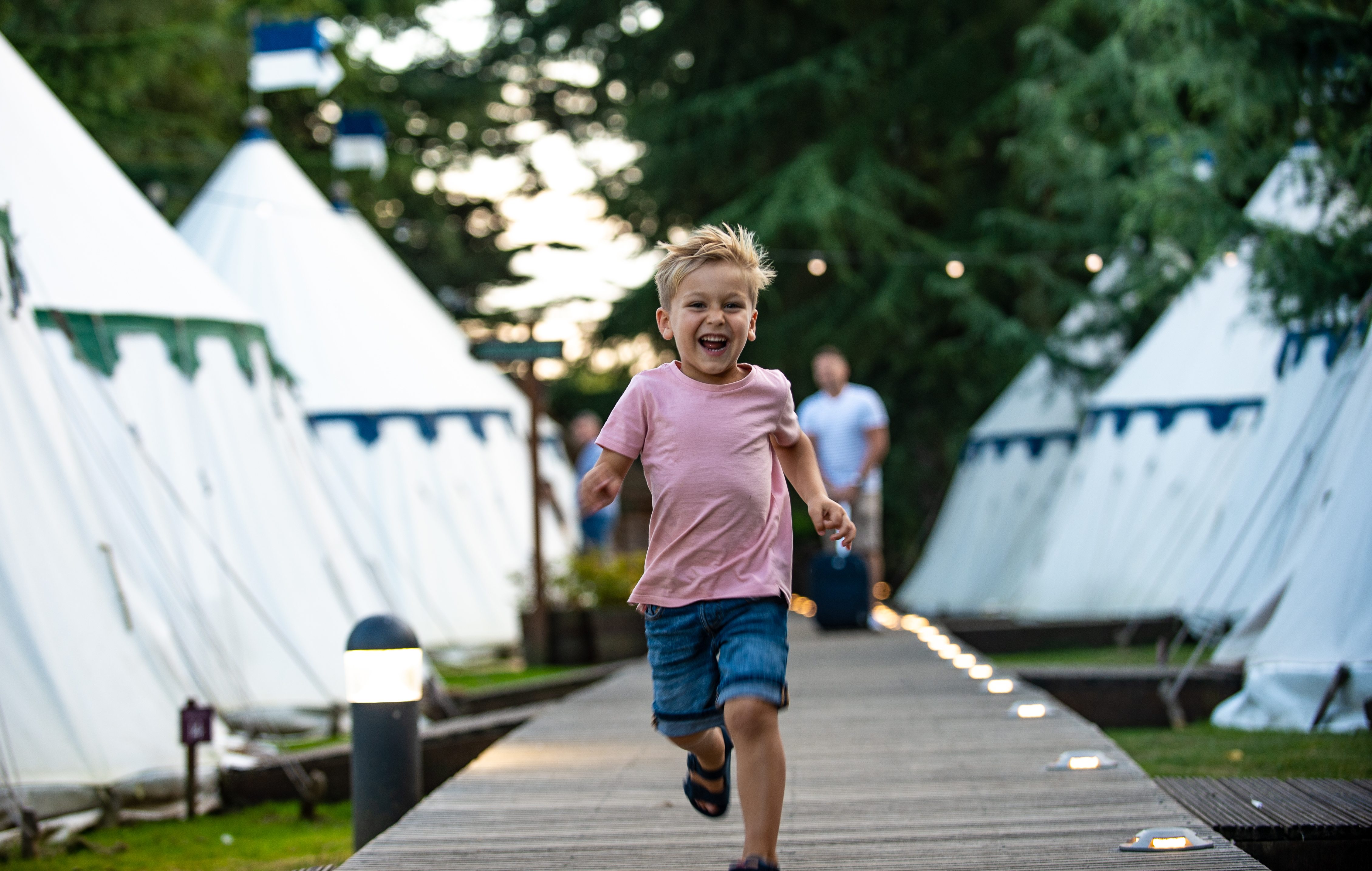 Boy running by tents