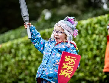 Girl cheering with sword and shield