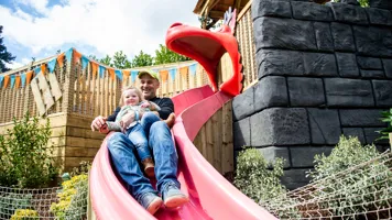 Dad and child on slide